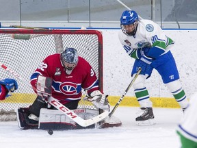 Kingston Voyageurs goaltender Alexei Masanko foils Burlington Cougars forward Wes Dobbin on a wraparound attempt during an Ontario Junior Hockey League game in 2018-19. (Tim Gordanier/Postmedia Network)