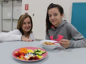 Lynn Paquette, with Noelle's Gift, left, is shown in this file photo visiting with pupil Mackenzie Sheppard during a breakfast program at P.E. McGibbon Public School in Sarnia. Student nutrition programs are among the services supported by Noelle's Gift, a Sarnia-area charity.