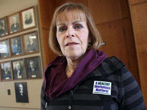 Coun. Anne Marie Gillis poses outside council chambers with a sticker she's been wearing since her recent mayoral campaign. She was defeated by Sarnia Mayor Mike Bradley. Other members of city council joined her Monday in wearing the stickers, alluding to workplace investigations in 2016 that found Bradley bullied and harassed city staff. (Tyler Kula/Sarnia Observer)
