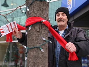 James Gough, a volunteer with Reseau ACCESS Network and who tested positive for HIV in 2001 because of drug use, participated in the launch of Bundle Up in Red HIV Awareness Week at the Durham Street RBC branch in Sudbury, Ont. on Monday November 26, 2018. The campaign utilizes red scarves to raise awareness about HIV. The scarves will be tied around lamp posts on city streets and trees at Bell Park and Memorial Park. Anyone who comes across a scarf is welcome to wear the item which is tagged with HIV facts. People are encourage to post a selfie wearing the scarf using the hashtag #BundleUpInRed.