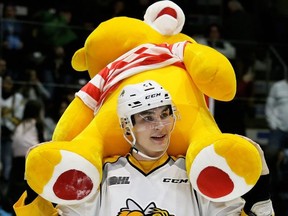 Sarnia Sting's Adam Ruzicka holds a bear after Jamieson Rees scored in the first period of their teddy bear toss game against the Kingston Frontenacs at Progressive Auto Sales Arena in Sarnia, Ont., on Saturday, Dec. 8, 2018. (Mark Malone/Postmedia Network)