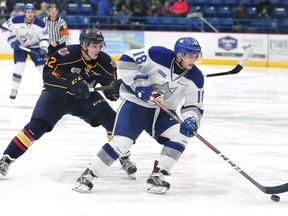 Owen Robinson, right, of the Sudbury Wolves, attempts to elude Matej Pekar, of the Barrie Colts, during OHL action at the Sudbury Community Arena in Sudbury, Ont. on Friday December 7, 2018. John Lappa/Sudbury Star/Postmedia Network