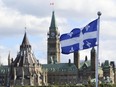 The Quebec flag is seen over-looking the Ottawa River behind Parliament Hill in Gatineau, Que., on Sept 19, 2012.