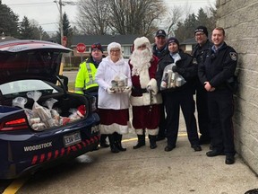The Woodstock Police Service Auxiliary Unit delivered 11 police cruisers full of non-perishable food items to the Salvation Army food bank as part of the 10th annual Fill-a-Cruiser event. (Submitted)