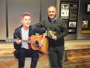 Stratford Perth Museum general manager John Kastner stands in the museum's Justin Bieber exhibit with his first book, Justin Bieber: Steps to Stardom, which details the unexpected and massive success that the exhibit has been for the small museum. Galen Simmons/The Beacon Herald/Postmedia Network