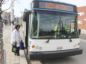 Kenora resident Valerie McIvor boards a public transit bus at the City Hall stop, one of 80 bus stops in the municipality.