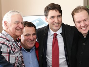 Prime Minister Justin Trudeau, second right, poses for a picture with Gary Duhaime (left), Nickel Belt MP Marc Serre, and  Sudbury MP Paul Lefebvre, right, at the Regent Street Deluxe location in Sudbury, Ont. on Wednesday February 13, 2019. John Lappa/Sudbury Star/Postmedia Network