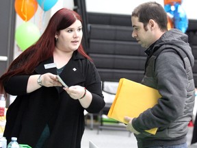 Brea-Anna Jacksic, a Northern Ontario commercial account manager with TD Canada Trust, speaks with Peter Stefanizzi during a job fair at Sault College in Sault Ste. Marie, Ont., on Wednesday, Feb. 7, 2018. (BRIAN KELLY/THE SAULT STAR/POSTMEDIA NETWORK)