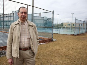 Sarnia Tennis Club president Shamel Hosni stands by the line between the club's tennis courts on city property and its courts on provincial land, behind the Sarnia Jail. The city recently agreed to enter negotiations for a land transfer with the province, amid rapidly rising fees for the club to use the provincial property. Tyler Kula/Sarnia Observer/Postmedia Network