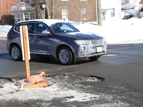 Drivers had to navigate around a massive pothole at the intersection of Regent and Douglas Streets in Sudbury, Ont. on Tuesday February 26, 2019. John Lappa/Sudbury Star/Postmedia Network