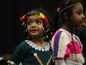 A young girl looks up during a dance presentation from the Ethiopian Cultural Group at the Multicultural Expo at MacDonald Island Park on Saturday, February 9, 2019. Vincent McDermott/Fort McMurray Today/Postmedia Network