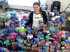 Erika Lougheed, manager at United Way Centraide North East Ontario, displays hundreds of  feminine hygiene products that were collected in the 2019 Tampon Tuesday campaign.