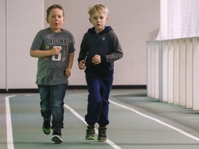 Sammy Jackson, left, and Kyptin Gardiner, both 7 and from Belleville, run on the indoor track at the Quinte Sports and Wellness Centre Friday, March 15, 2019. The centre is open today as a cooling centre.