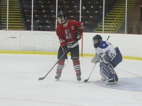 Brockville Captain Hunter Shipclark parks in front of Perth goaltender Johnathan Peacock during game four of the Tikis-Blue Wings quarter-final playoff series at the Brockville Memorial Centre on Saturday night. Shipclark had scored earlier in the first period to tie the game 1-1; Peacock ended up making 25 saves in Perth's 8-3 victory. The Blue Wings lead the best-of-seven series 3-1 and host game five on Tuesday night.
Tim Ruhnke/The Recorder and Times