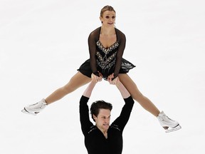 Michael Marinaro of Sarnia, Ont., lifts partner Kirsten Moore-Towers during the pairs competition at the ISU Four Continents figure skating championship Feb. 9, 2019, in Anaheim, Calif. Mark Ralston/Getty Images