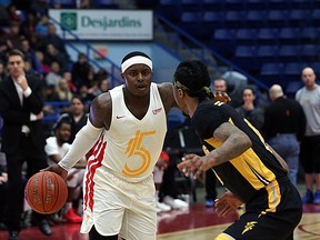 Braylon Rayson of the Sudbury Five handles the ball while Mo Bolden of the London Lightning defends during first-half National Basketball League of Canada action at Sudbury Community Arena in Sudbury, Ontario on Sunday, March 24, 2019.