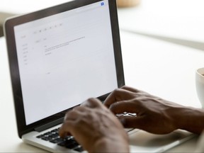 Person typing at laptop keyboard