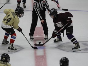 Two players battle for  the puck during a minor hockey game at William Allman Memorial Arena in Stratford before the pandemic. On Wednesday, local rec centres will reopen but most users will be required to show proof of vaccination before entering.
(File photo)