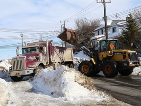 A crew removes snowbanks on Spruce Street in Sudbury, Ont. on Monday March 18, 2019. John Lappa/Sudbury Star/Postmedia Network