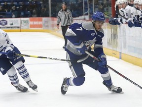 Isaak Phillips, right, of the Sudbury Wolves, skates past James Hardie, of the Mississauga Steelheads, during OHL playoff action at the Sudbury Community Arena in Sudbury, Ont. on Friday March 22, 2019.