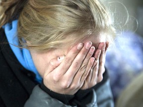 A young woman who was the victim of human trafficking. Her face is covered to protect her identity. Derek Ruttan/Postmedia Network