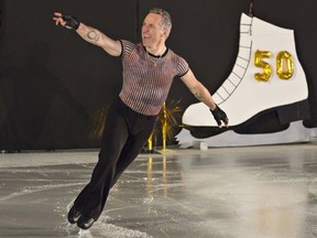 Elvis Stojko gestures to the crowd during his routine in this file photo.