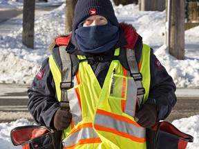 A Canada Post letter carrier struggles to keep warm.