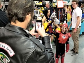 Robby Eccleshall takes a photo of his son Eries, dressed as the Red Lantern, holding a replica weapon from one of the vendors at the Cornwall and Area Pop Event on Sunday April 28, 2019 in Cornwall, Ont. Greg Peerenboom/Special to the Cornwall Standard-Freeholder/Postmedia Network