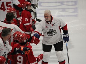 As popular retired Toronto Maple Leaf Rick Vaive is introduced over the public address system, he fist bumps his way down the line of NHL Alumni Team players and players from Pembroke Minor Hockey. (FILE)
