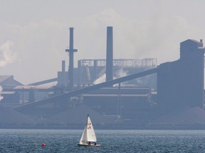 A sailboat sails past the Stelco plant in Hamilton, Ont. in this Aug. 27, 2007 file photo. THE CANADIAN PRESS/Adrian Wyld ORG XMIT: cpt114