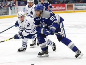 Quinton Byfield, right, of the Sudbury Wolves, skates around Nicholas Canade, of the Mississauga Steelheads, during OHL playoff action at the Sudbury Community Arena in Sudbury, Ont. on Friday March 22, 2019.