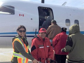 Ranger Rosaline Sutherland helps evacuees get onto evacuation planes in Kashechewan First Nation.