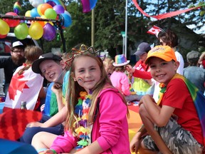 Toban Fortier, Daphne Mohr and Elliot Mohr pose with the Airdrie Pride Society on Canada Day. The Society has announced the inaugural Pride Festival to be held on June 22. - Submitted