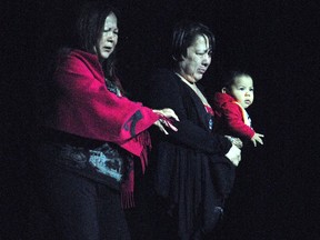 Barbara McDonald and Mary Ann Barbara and her foster child walk onstage in memory of missing and murdered Akwesasne woman Carleen McDonald, at the Port Theatre as part of Sacred Songs - Singing for the Silenced, on Friday February 20, 2009 in Cornwall, Ont. Greg Peerenboom/Special to the Cornwall Standard-Freeholder/Postmedia Network