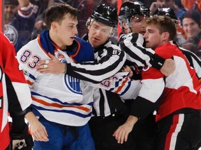 Chris Wideman of the Ottawa Senators and Matthew Benning of the Edmonton Oilers are separated by linesman Devin Berg, of Gadshill, and linesman Brad Kovachik, of Woodstock, after exchanging punches at Canadian Tire Centre on Jan. 8, 2017 in Ottawa.