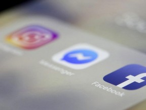 In this March 13, 2019 file photo, Facebook, Messenger and Instagram apps are are displayed on an iPhone.