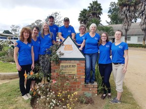 Mission Zimbabwe 2019 team members pose for a photo at the entrance of the Village of Hope.