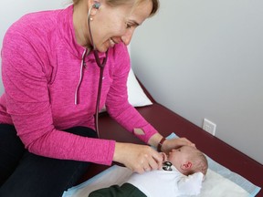 Kingston midwife Iryna Didyk performs a check-up on a two-week-old at the Community Midwives of Kingston office in April 2019.