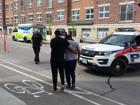 An occupant of one of three vehicles involved in a collision at Princess and Victoria streets on May 30, 2019, is assisted by Frontenac Paramedics. (Elliot Ferguson/The Whig-Standard)