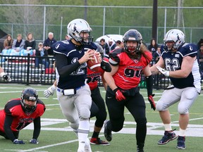 Sudbury Spartans quarterback Hunter Holub (12) prepares to throw a pass while being pressured by Oakville Longhorns defenders during Northern Football Conference action at James Jerome Sports Complex in Sudbury, Ontario on Saturday, May 25, 2019.