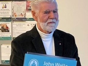Former long-time Norfolk County Coun. John Wells died on Tuesday.  In this photo from 2019, Wells holds the plaque for the John Wells Reading Lounge at the Port Dover library named in his honour.