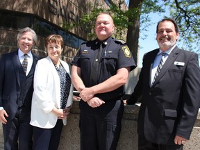 Sarnia Police Chief Norm Hansen stands with Accident Support Services International vice presidents Rick Yates, left, and Lynn Hemingway, and Sarnia collision reporting centre manager Brent Gillen, right, outside the Sarnia Police station where the collision centre officially opened on June 11. The collision centre is open Monday to Friday, 10 a.m. to 6 p.m. (Tyler Kula/Sarnia Observer)