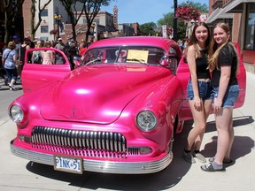 Emma Charron, left, and Callie Butler, both 15, took a fancy to this 1951 Chevy Coupe owned by Al Holland, which was among the more than 800 vehicles featured during RetroFest in downtown Chatham, Ont. on Saturday June 22, 2019. Ellwood Shreve/Chatham Daily News/Postmedia Network