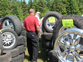 Shoppers and browsers check out tires and rims at the Bonfield Automotive Flea Market, held at the Bonfield Event Park. PJ Wilson/The Nugget Nugget File Photo