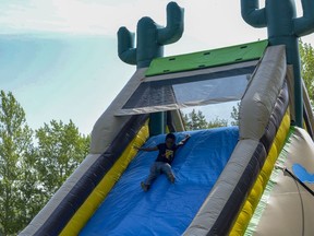 Six-year-old Micah takes a ride down the slide on Saturday, June 1, 2019 at the Children's Festival.