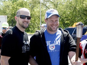 Brockville Police Const. Dustin Gamble, left, and Brandon Gobiel get ready to lead the Law Enforcement Torch Run for Special Olympics in 2019. (FILE PHOTO)