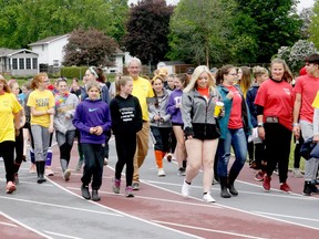 Cancer survivors are joined by TISS students as they complete the survivors' lap to start the Brockville school's Relay for Life in June 2019. File photo/The Recorder and Times