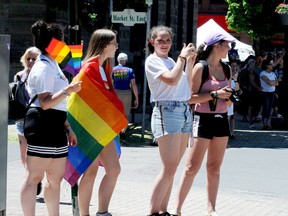 South Grenville District High School students, from left, Gaia Sisto, Sierra Letts, Laura Calderon and Valentina Targa wave in support of the 2019 Pride Parade in Brockville. (FILE PHOTO)