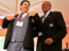 Philadelphia Phillies coach Rob Thomson, left, of Corunna, Ont., receives his Hall of Fame jacket from Fergie Jenkins during the Canadian Baseball Hall of Fame induction ceremony in St. Marys, Ont., on Saturday, June 15, 2019. (Cory Smith/Postmedia Network)