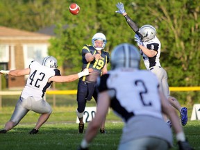 PETER RUICCI
With pressure from Sudbury's Andrew Gillis (left) and Dallas Hall, Sault Steelers quarterback Darrell Wood uncorks a  pass in Northern Football Conference action.
